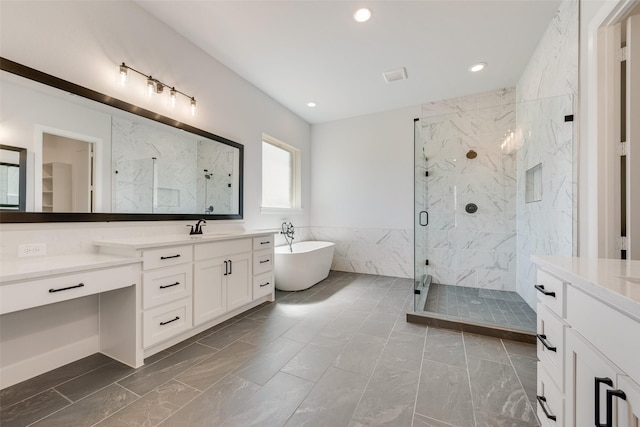 full bathroom with vanity, a marble finish shower, marble finish floor, and a freestanding bath