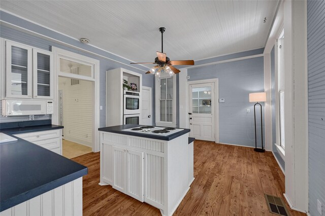 doorway to outside featuring wood finished floors and ceiling fan