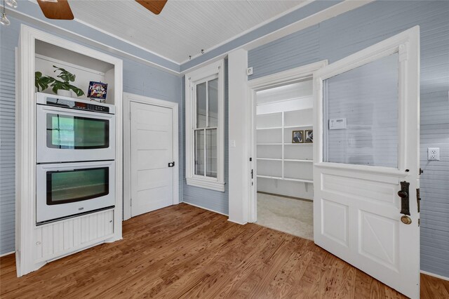 hall with a sink, light wood-type flooring, baseboards, ornamental molding, and recessed lighting