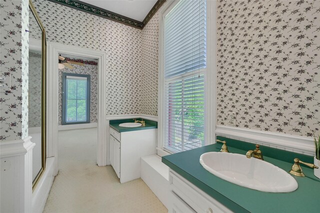 unfurnished bedroom with a ceiling fan, wallpapered walls, carpet floors, baseboards, and visible vents