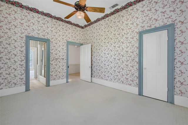 bathroom with a wealth of natural light, a wainscoted wall, a sink, and wallpapered walls