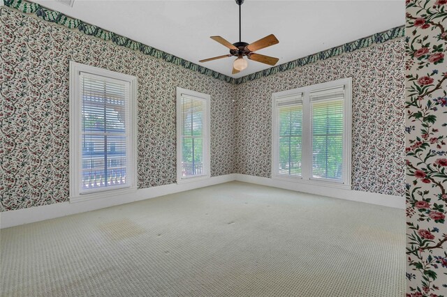 full bath with a chandelier, wallpapered walls, a stall shower, and a sink