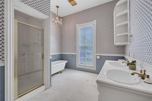 carpeted empty room with wallpapered walls, a ceiling fan, and baseboards