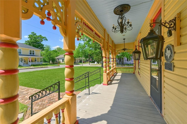 deck with a lawn and a porch