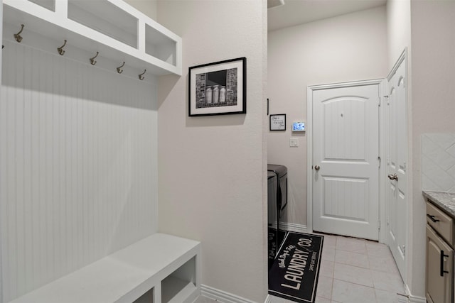 mudroom featuring baseboards and light tile patterned flooring