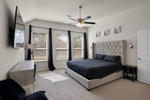 bedroom with vaulted ceiling, visible vents, baseboards, carpet flooring, and ceiling fan