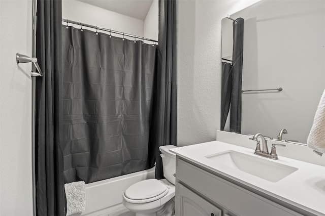 full bath featuring shower / bath combo, vanity, and toilet