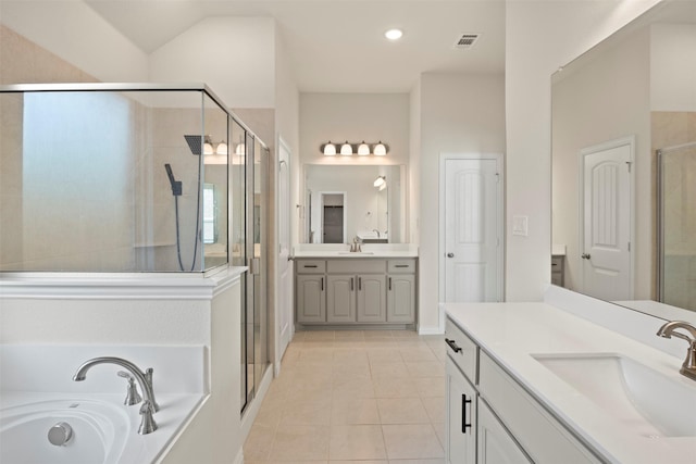 bathroom featuring tile patterned floors, visible vents, a sink, and a stall shower