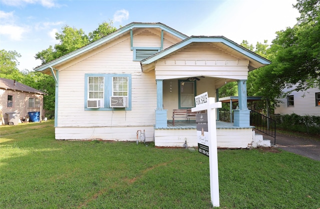 bungalow-style house with a porch and a front lawn