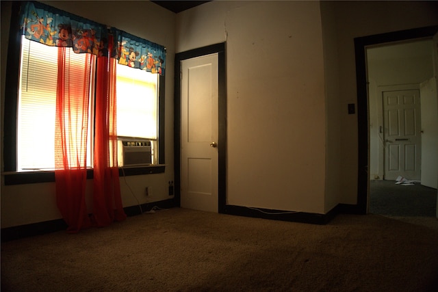 1530 Southerland Ave, Dallas, TX 75203 - spare room featuring baseboards, carpet flooring, and cooling unit