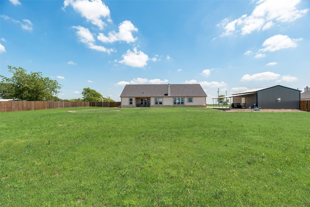 back of house featuring a lawn and fence
