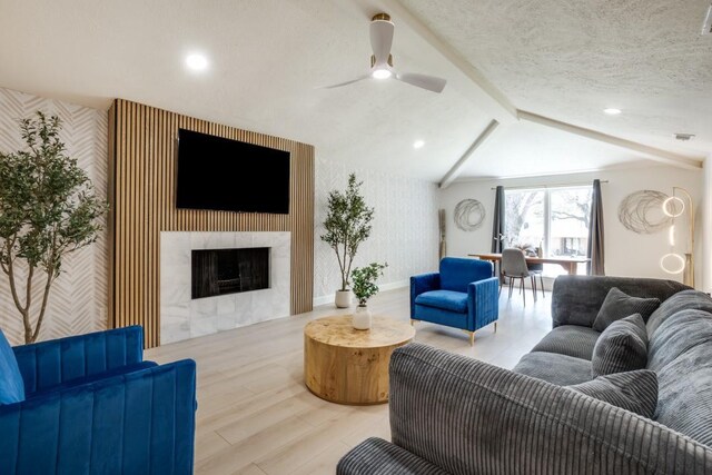 4043 Flintridge Dr, Dallas, TX 75244 - living room featuring ceiling fan, an accent wall, wood finished floors, and wallpapered walls