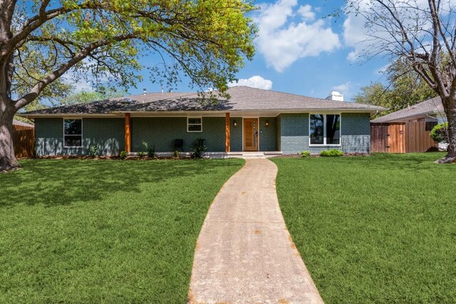 4043 Flintridge Dr, Dallas, TX 75244 - single story home with brick siding, a chimney, and a front yard