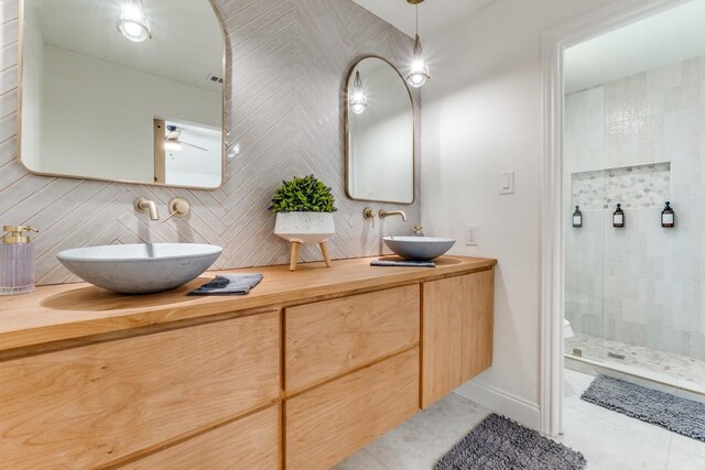 4043 Flintridge Dr, Dallas, TX 75244 - bathroom with tasteful backsplash, double vanity, a stall shower, and a sink