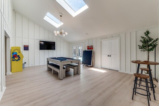 4043 Flintridge Dr, Dallas, TX 75244 - recreation room with high vaulted ceiling, a decorative wall, a skylight, billiards, and light wood-style flooring