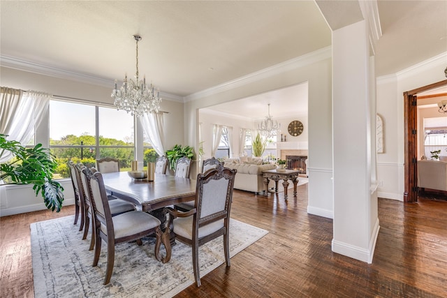 1241 Yuma Dr, Frisco, TX 75033 - dining space with crown molding, a chandelier, and dark wood finished floors