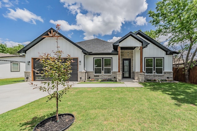 view of front facade featuring driveway, fence, a garage, board and batten siding, and a front yard