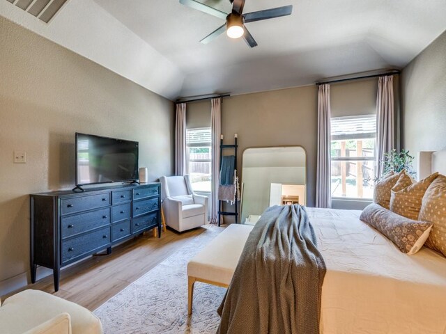 bedroom featuring lofted ceiling, a ceiling fan, and light wood finished floors