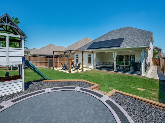 view of playground featuring a fenced backyard, a yard, and a trampoline