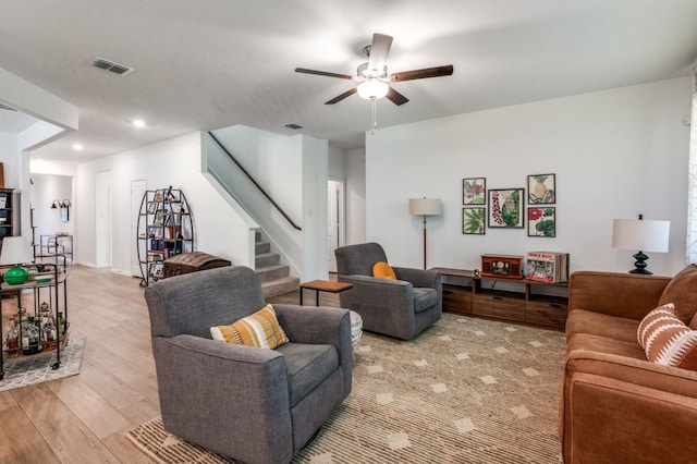 living area featuring visible vents, stairway, recessed lighting, a ceiling fan, and light wood finished floors