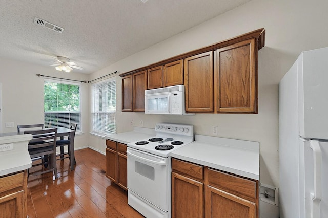 8413 Vicksburg Ln, Fort Worth, TX 76123 - kitchen with white appliances, a ceiling fan, light wood-style flooring, light countertops, and a textured ceiling