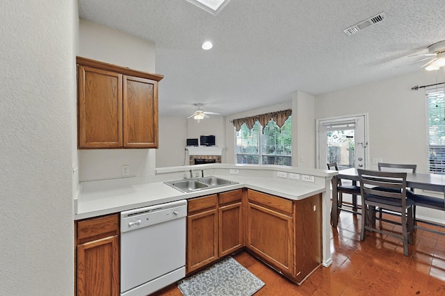 8413 Vicksburg Ln, Fort Worth, TX 76123 - kitchen with dishwasher, a ceiling fan, a sink, a peninsula, and a textured ceiling