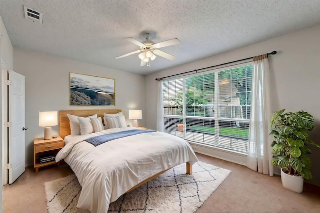 8413 Vicksburg Ln, Fort Worth, TX 76123 - bedroom with light colored carpet, a textured ceiling, and a ceiling fan