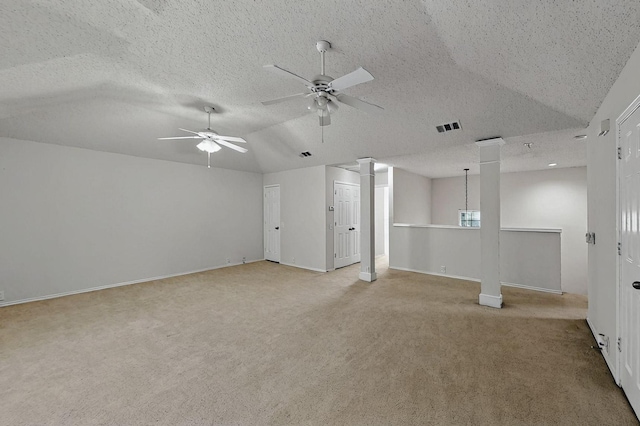 8413 Vicksburg Ln, Fort Worth, TX 76123 - spare room featuring lofted ceiling, light carpet, ceiling fan, baseboards, and ornate columns