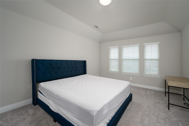 carpeted bedroom featuring baseboards, visible vents, and lofted ceiling