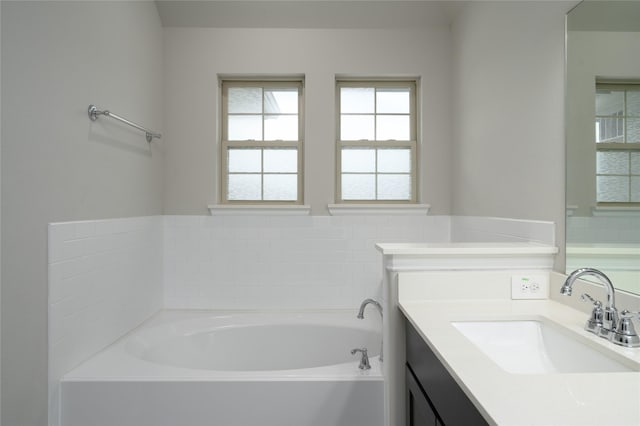 bathroom featuring a bath and vanity