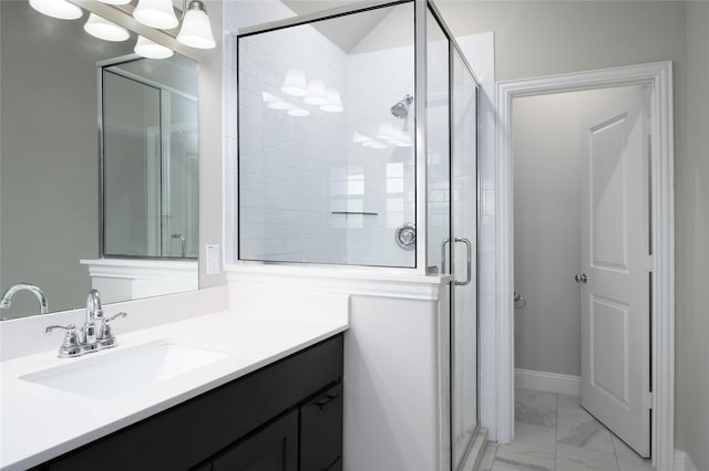bathroom featuring vanity, baseboards, a shower stall, and marble finish floor