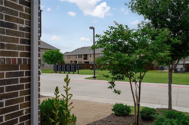 view of road featuring street lights and curbs