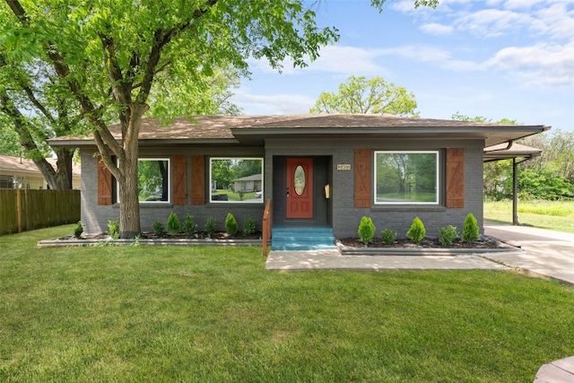 ranch-style house featuring fence, a front lawn, and brick siding