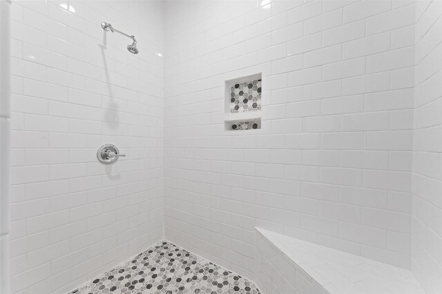 full bathroom with a tile shower