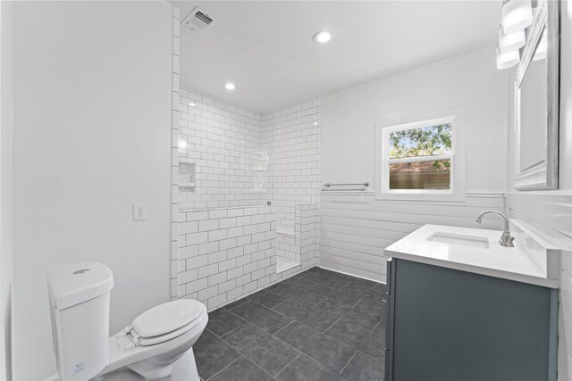 bathroom featuring vanity, walk in shower, toilet, tile patterned flooring, and visible vents