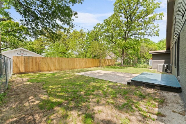 view of yard featuring a fenced backyard, central air condition unit, and a patio area