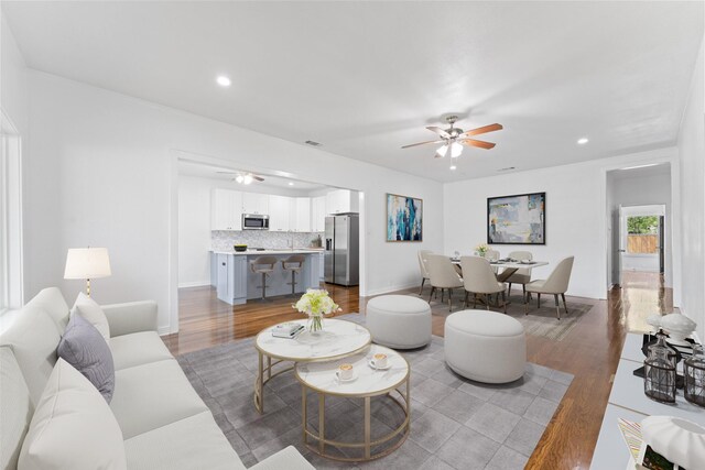living area featuring recessed lighting, light wood finished floors, and ceiling fan