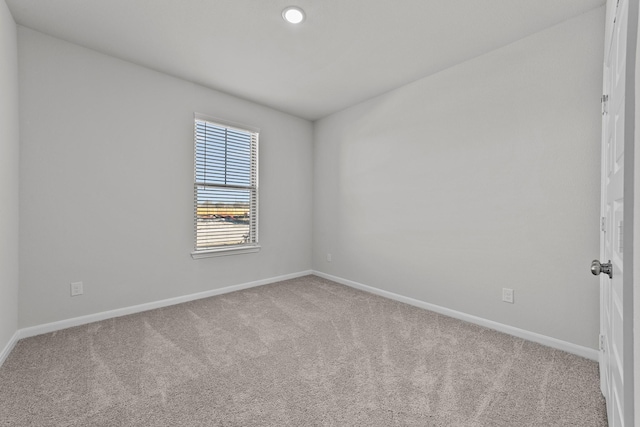 empty room with baseboards and carpet flooring