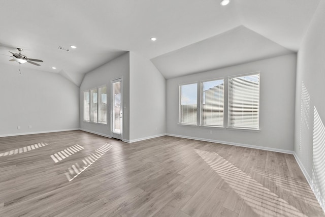 unfurnished living room featuring vaulted ceiling, a ceiling fan, light wood-style floors, baseboards, and visible vents