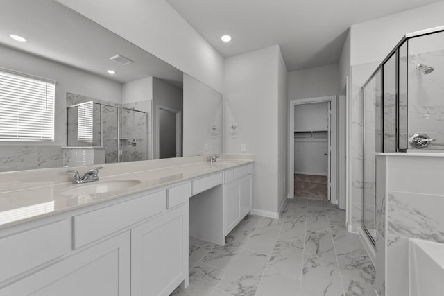 bathroom with a sink, a stall shower, a walk in closet, marble finish floor, and visible vents