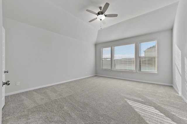spare room with ceiling fan, carpet floors, lofted ceiling, and baseboards
