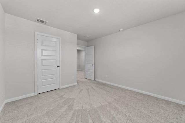unfurnished bedroom featuring carpet, visible vents, and baseboards