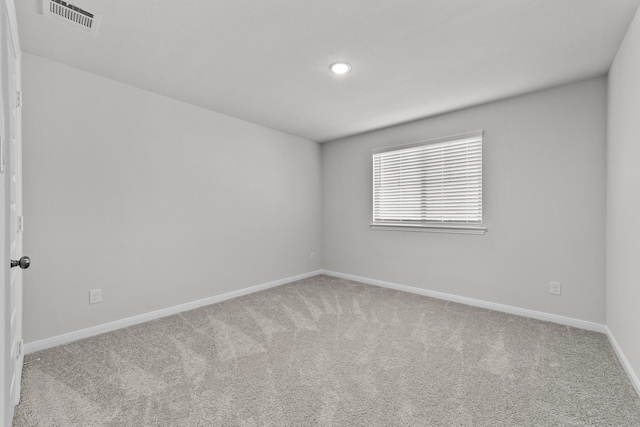 empty room with visible vents, baseboards, carpet floors, and recessed lighting