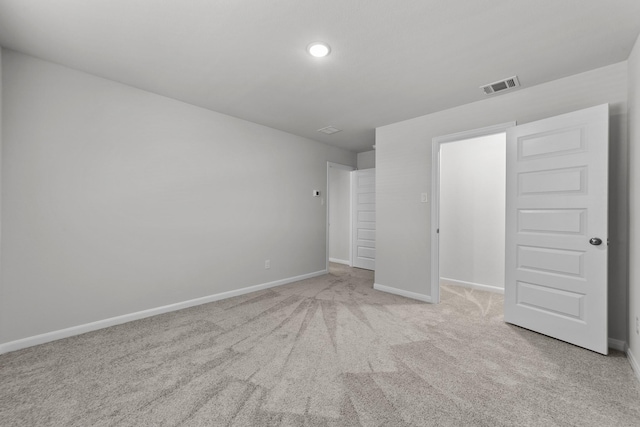 unfurnished bedroom featuring baseboards, carpet floors, visible vents, and recessed lighting