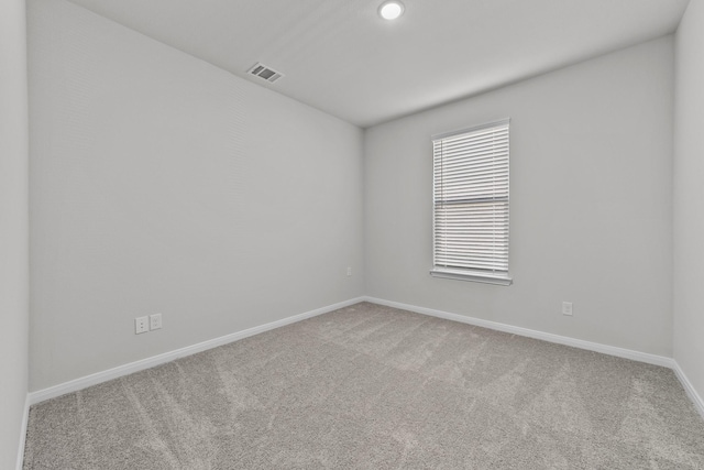 carpeted empty room featuring recessed lighting, visible vents, and baseboards