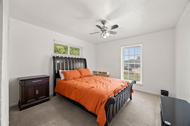 bedroom with light colored carpet, a ceiling fan, and baseboards