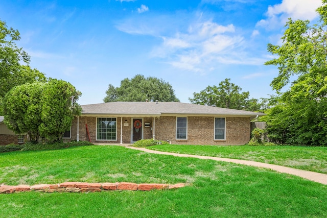 ranch-style house featuring brick siding and a front lawn
