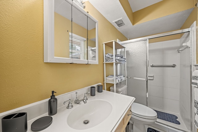 full bathroom featuring toilet, a textured wall, visible vents, and a stall shower