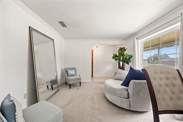 sitting room featuring baseboards, visible vents, ornamental molding, and light colored carpet