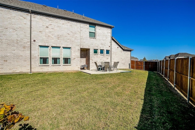 16900 Sophora Ave, Justin, TX 76247 - back of property with a patio area, a lawn, and a fenced backyard